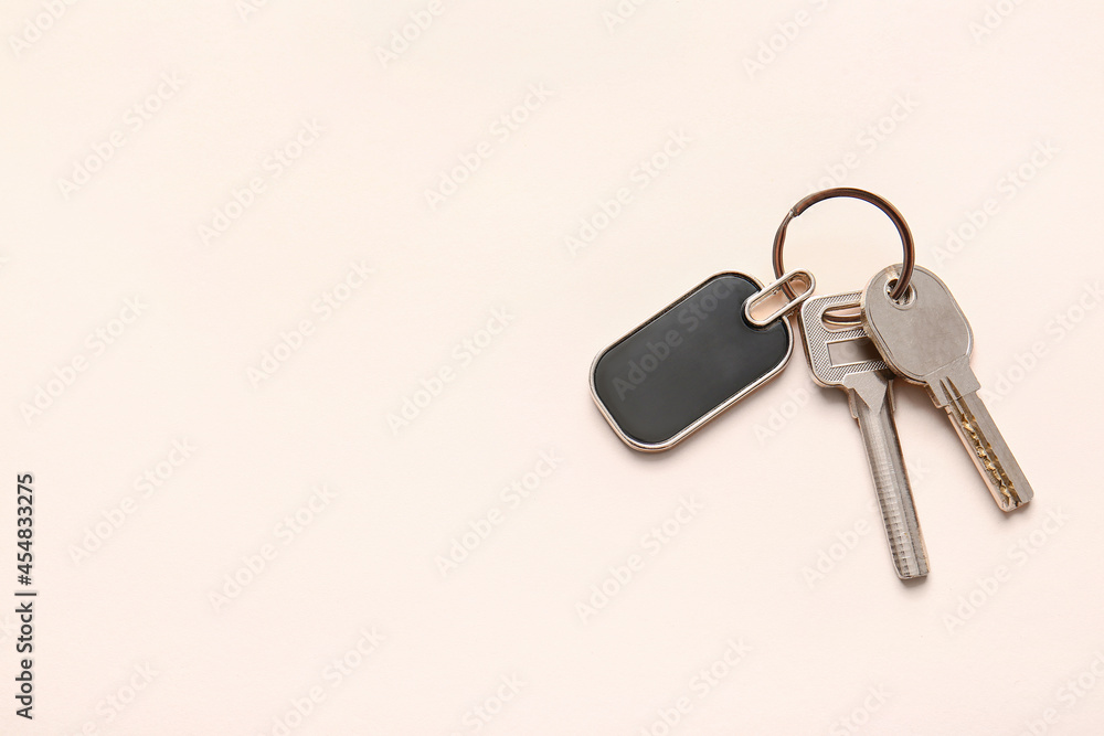 Keys with stylish keychain on light background Keys with stylish keychain on light background