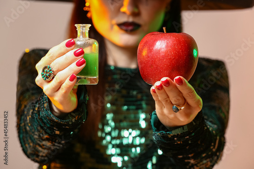 Young witch with apple and ...
