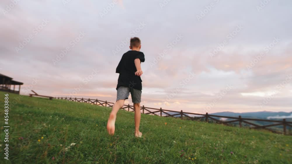 Boy playing with plane in mountains