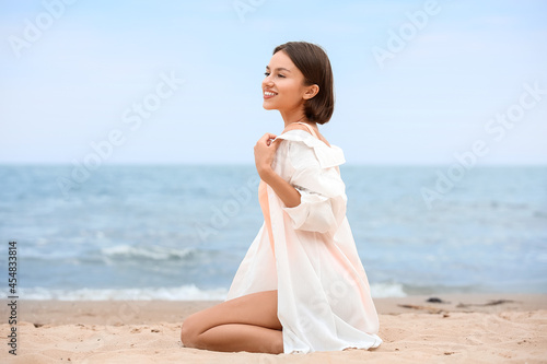 Beautiful young woman on sea beach