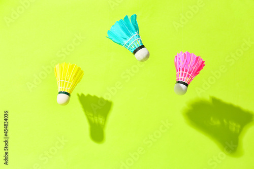 Badminton shuttlecocks on color background