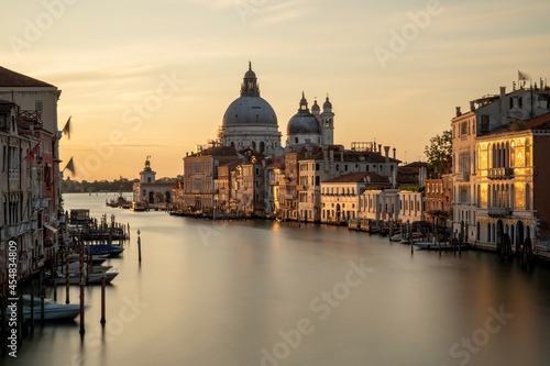 Venice, Italy. Sunrise view of the Grand Canal and Basilica Santa Maria della Salute. Focus on basilica, boats slightly blurred by long exposure. © PetraJPhoto