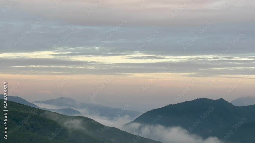 a beautiful view of mountains with clouds at dawn, time-lapse a beautiful view of mountains with clouds at dawn, time-lapse