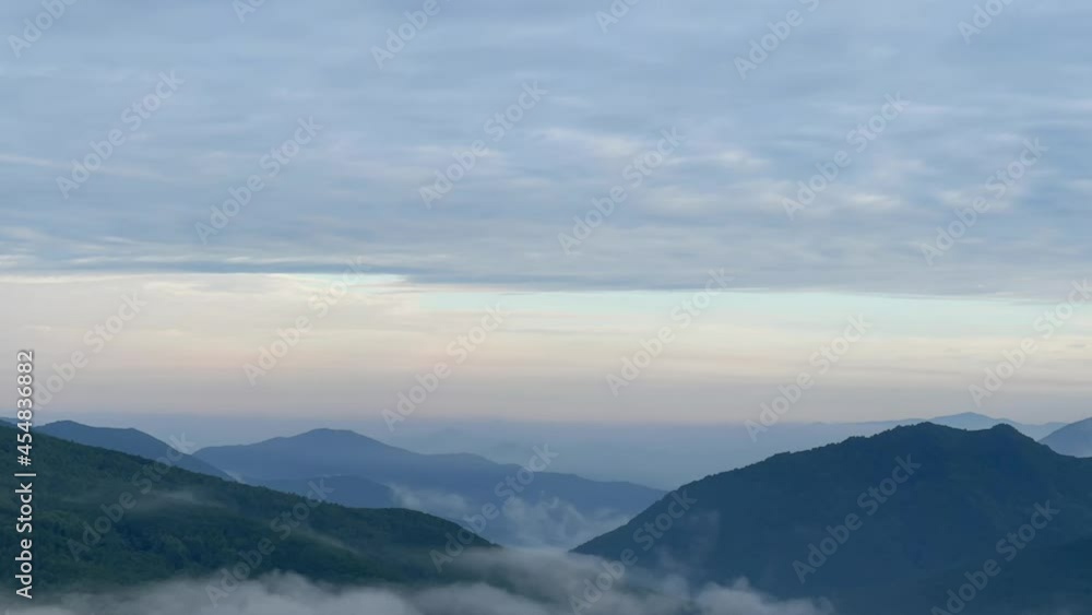 a beautiful view of mountains with clouds at around sunrise, time-lapse a beautiful view of mountains with clouds at around sunrise, time-lapse