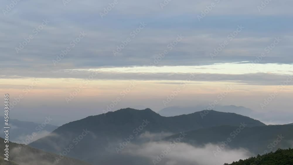 a beautiful view of mountains with clouds at around sunrise, time lapse a beautiful view of mountains with clouds at around sunrise, time lapse