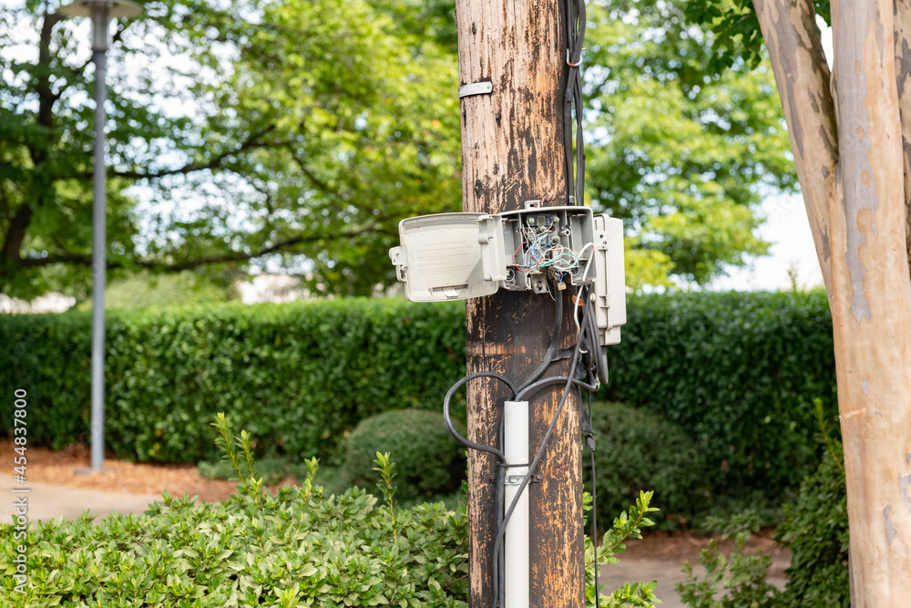 Utility pole with dangerous exposed wiring in an open box Utility pole with dangerous exposed wiring in an open box