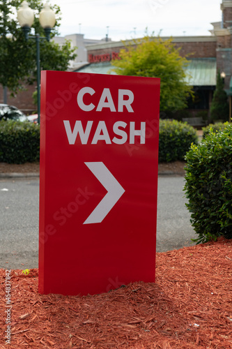 Red and white car wash sign with a shallow depth of field