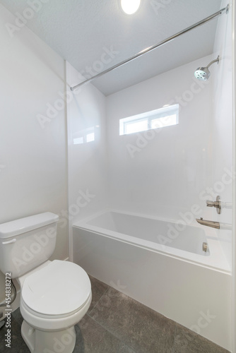 White bathroom interior with windows and gray tiles flooring