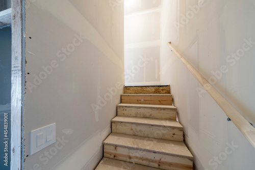 Under construction of a wooden staircase of a basement