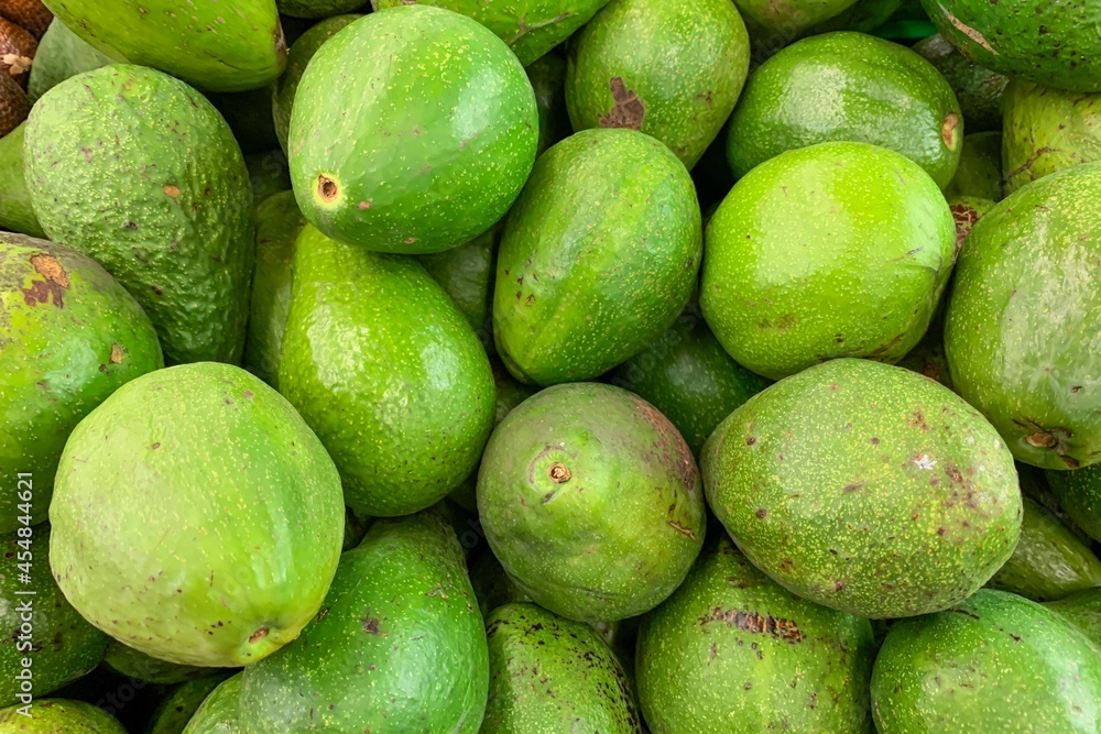 Green avocados in the supermarket, for background Green avocados in the supermarket, for background