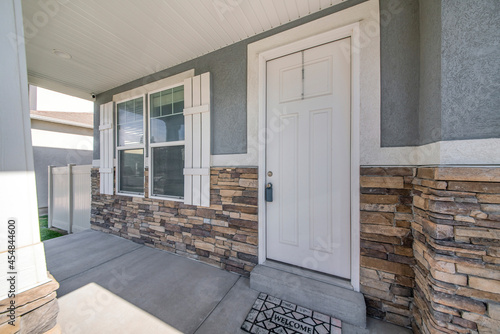 Exterior of a house with gray and stone veneer siding photo