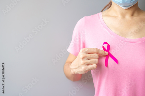 October Breast Cancer Awareness month  elderly Woman in pink T- shirt with hand holding Pink Ribbon for supporting people living and illness. International Women  Mother and World cancer day concept