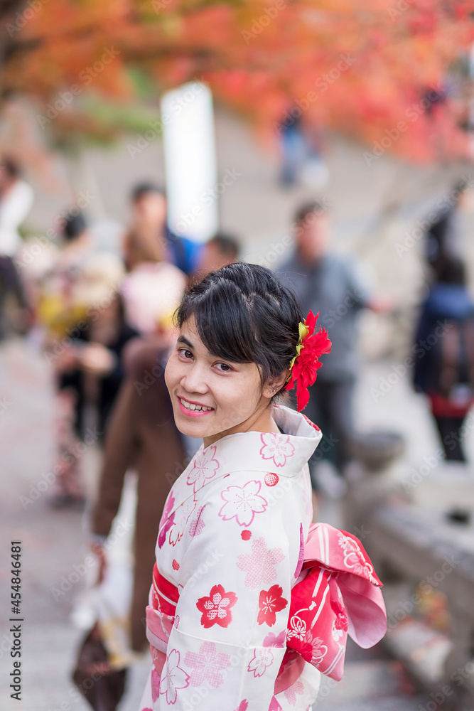young woman tourist wearing kimono enjoying with colorful leaves in temple, Kyoto, Japan. Asian girl with hair style in traditional Japanese clothes in Autumn foliage season young woman tourist wearing kimono enjoying with colorful leaves in temple, Kyoto, Japan. Asian girl with hair style in traditional Japanese clothes in Autumn foliage season