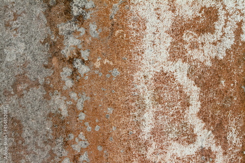 The orange and black background plaster walls are old and dirty