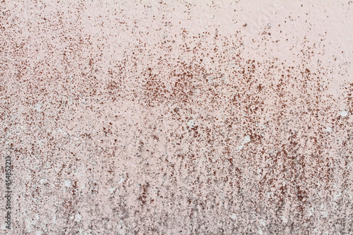 The pink and black background plaster walls are old and dirty