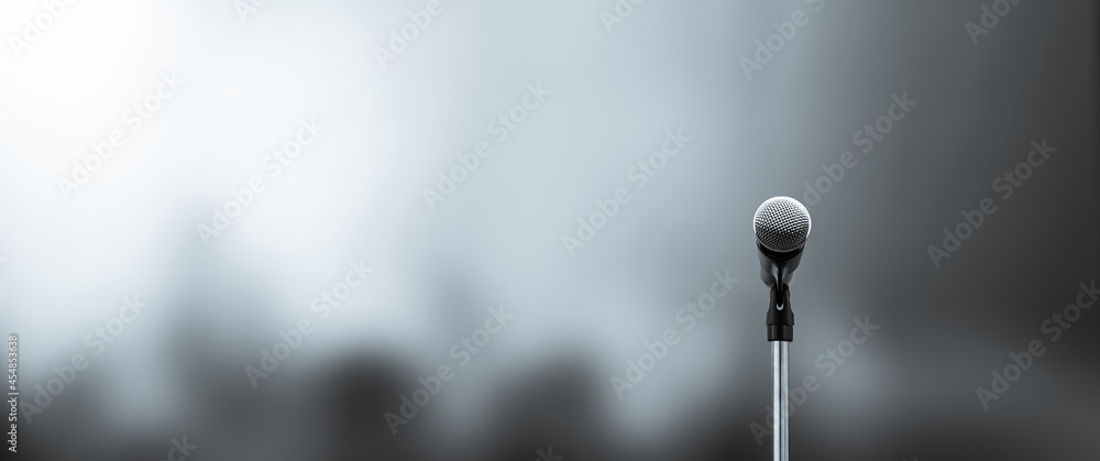 Microphone Public speaking background, Close-up the microphone on stand for speaker speech presentation stage performance with blur and bokeh light background. - obrazy, fototapety, plakaty 