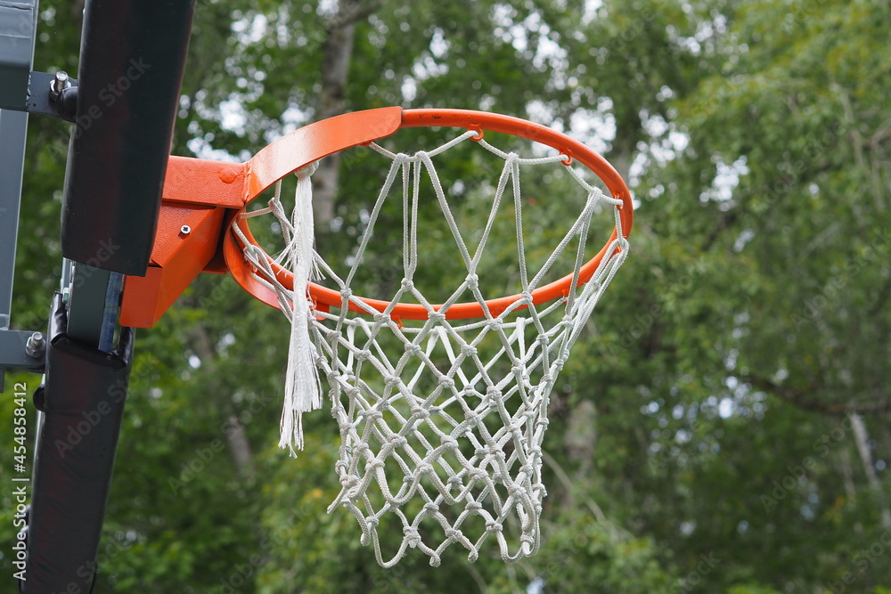basketball hoop with net on a sports ground in an outdoor park.