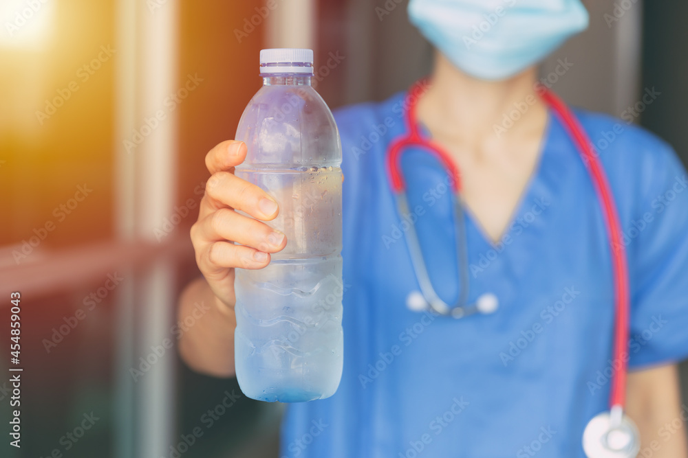 Doctor Nurse giving or recommend drinking clean cool water in hot summer for prevent dehydration. Doctor Nurse giving or recommend drinking clean cool water in hot summer for prevent dehydration.