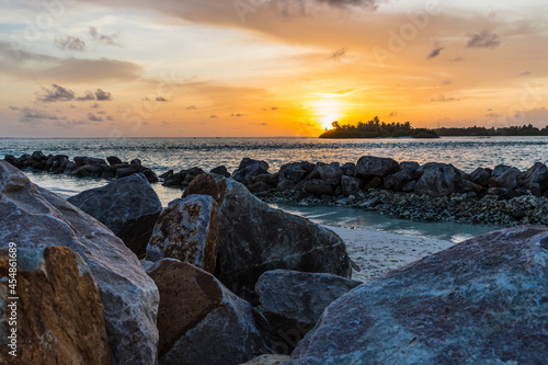 beach with large rocks at sunset in the Maldives