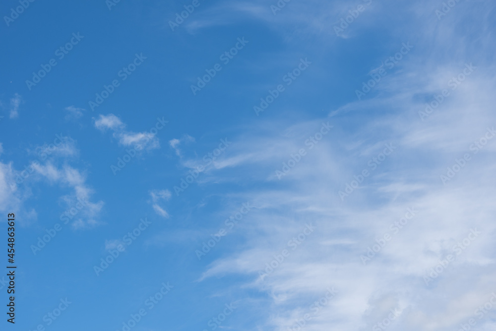 Beautiful cirrus clouds in the blue morning sky. Background of blue sky and white cirrus clouds in summer for your photos, mockup for design.