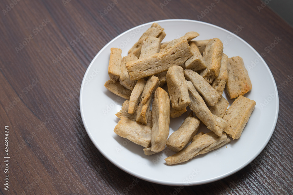 Malaysia delicacy Fish Crackers on a white plate (Keropok Lekor) Malaysia delicacy Fish Crackers on a white plate (Keropok Lekor)
