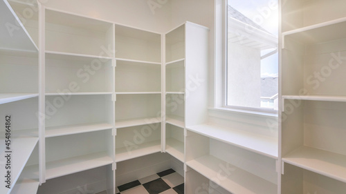 Pano Interior of an empty kitchen pantry in a house with window