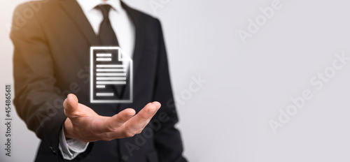 Hand holding a document icon in his hand Document Management Data System Business Internet Technology Concept. Corporate data management system DMS