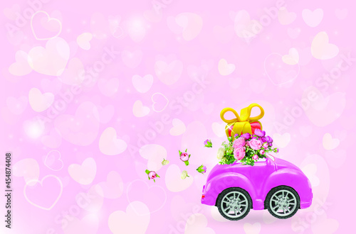 Pink retro car with gift box on a roof with flowers on pink background. Vector