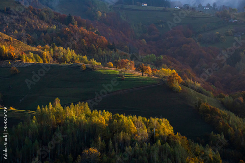 Moody autumn landscape in a rural Transylvanian village. © belyaaa