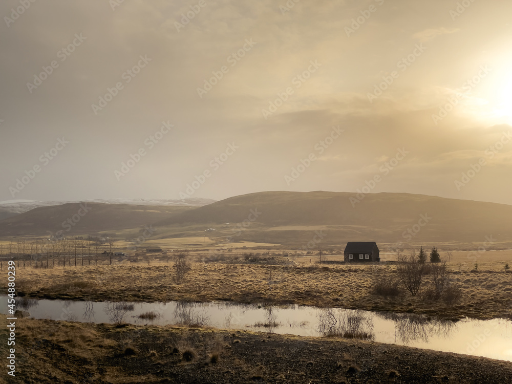 Fototapeta premium Lonesome house located in grassy hilly countryside