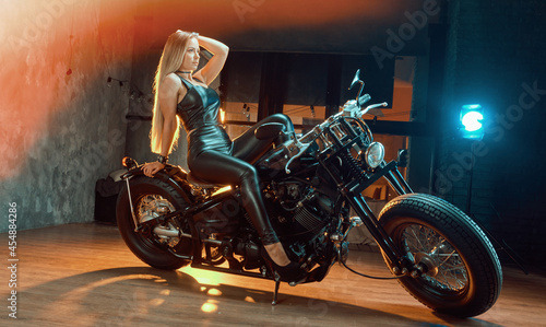 Fototapeta Naklejka Na Ścianę i Meble -  Young  woman sitting on motorcycle