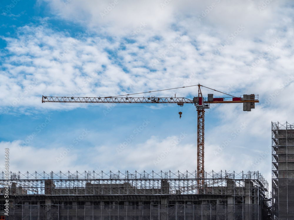 Building under construction, cranes and high-rise building Building under construction, cranes and high-rise building