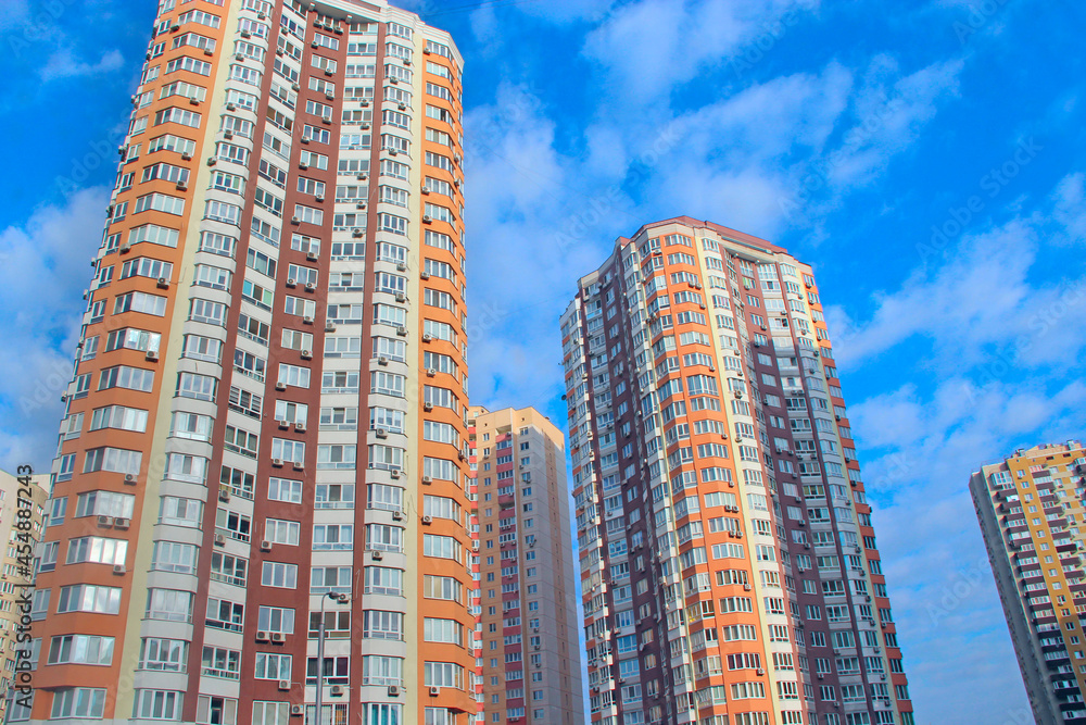 high modern skyscraper and blue sky. View of residential multi-storey buildings