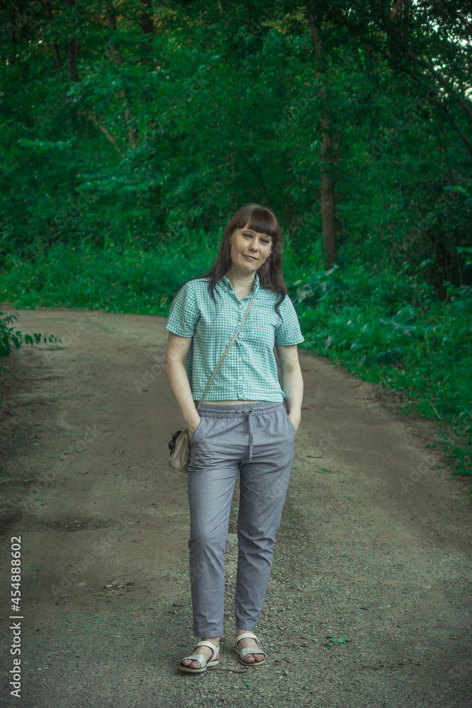 a brunette girl is standing on the road a brunette girl is standing on the road