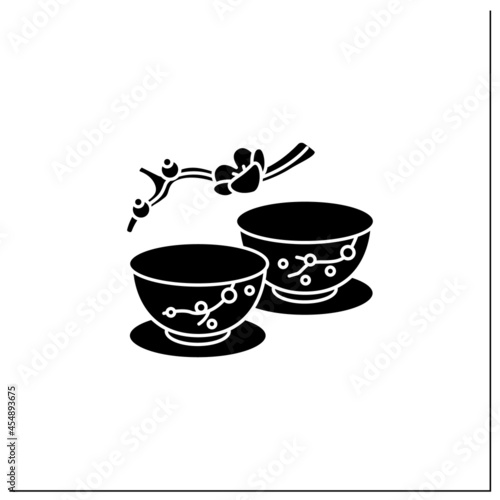 Japanese tea cups glyph icon. Ceremony two teacups with sakura pictures. Unique handmade ware. Tea ritual concept.Filled flat sign. Isolated silhouette vector illustration