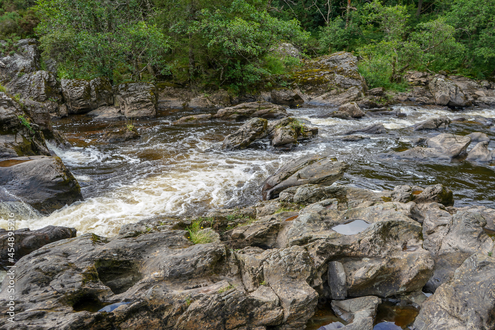 Water flowing over rocks in a river Water flowing over rocks in a river