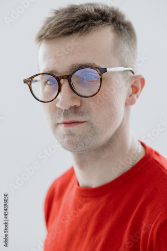 portrait of a handsome and young Caucasian man in a red sweater  entrepreneur  model or stylist young adult man in glasses  director or freelancer  male marketer or engineer