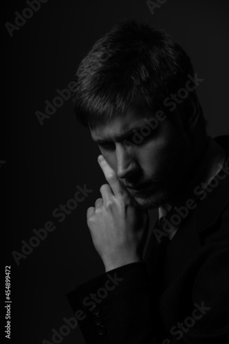Young confident caucasian man in suit in black and white. Business concept