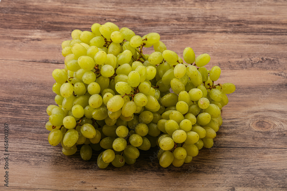 Green grape branch over background Green grape branch over background