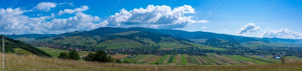 Panoramic view of a hungarian village called Csikszentgyorgy in hungarian, Ciucsangeorgiu in romanian from the top of the mountain in Transylvania, Romania.