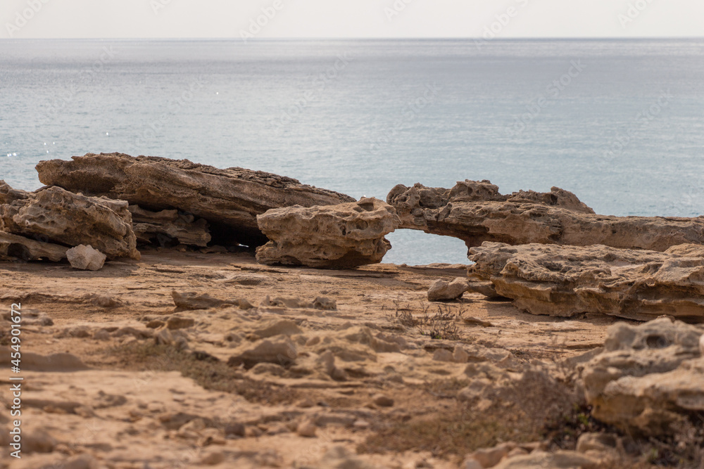 Rocky coastline with sea on background around Cape Greco, Cyprus.