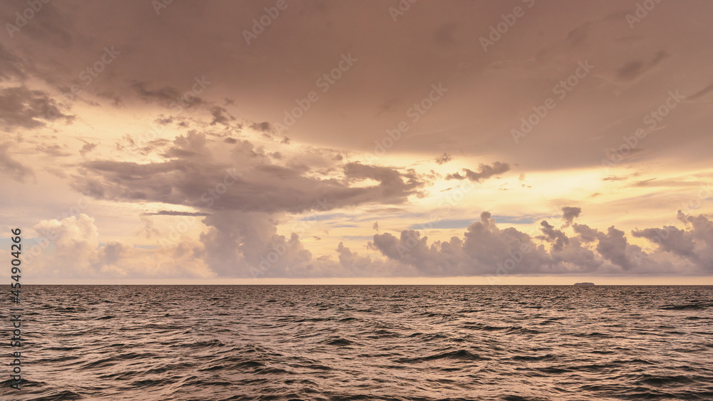 Fototapeta premium Nature in twilight period which including of sunrise over the sea and the nice beach. Summer beach with blue water and purple sky at the sunset. 