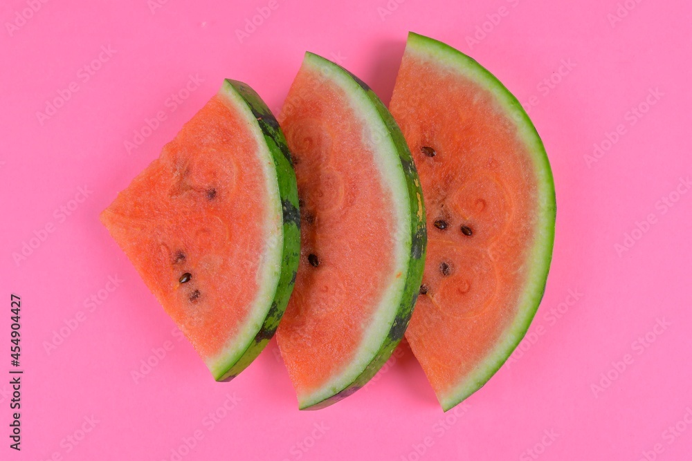 Sliced watermelon on pink background. Pieces of watermelon isolated on pink background. Flat lay