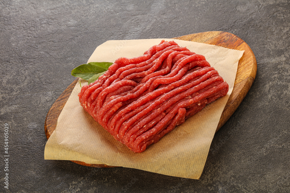 Raw beef minced meat over board Raw beef minced meat over board