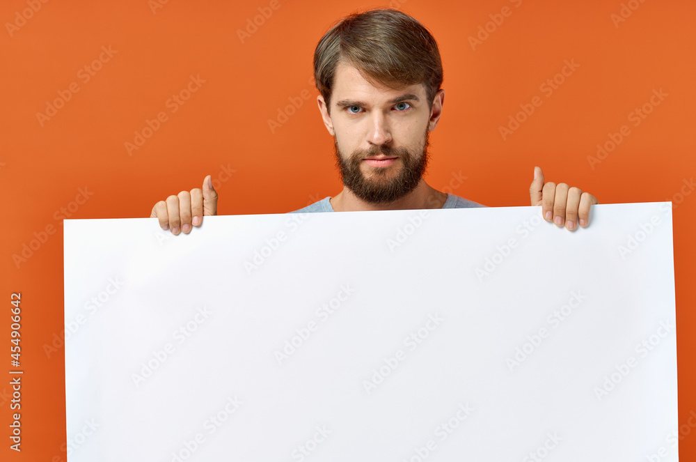 bearded man holding a mockup poster discount orange background bearded man holding a mockup poster discount orange background