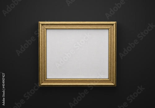 The bronze color picture horizontal frame on black wall with textured blank canvas, 3D mockup