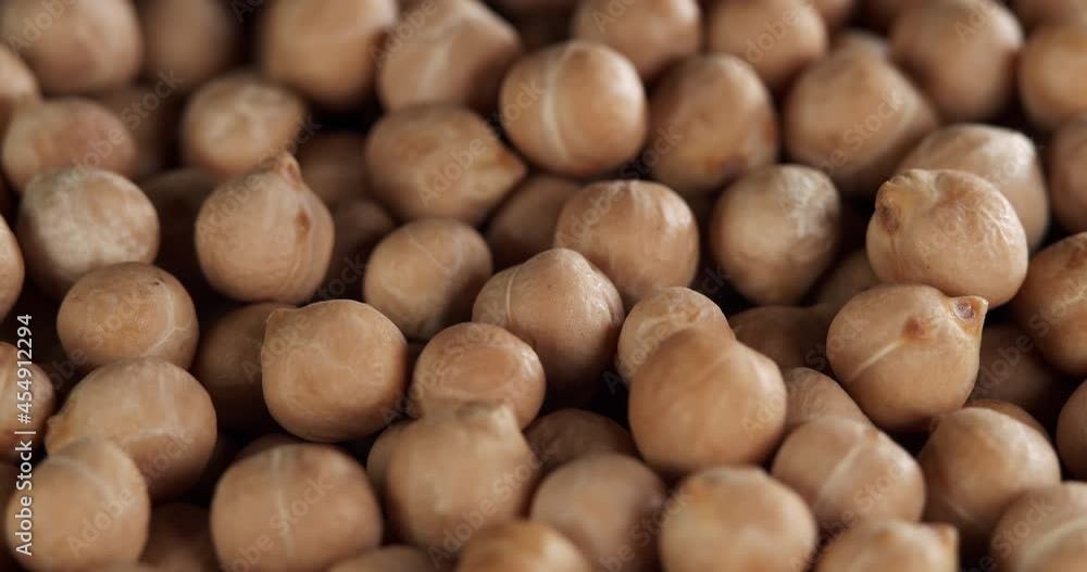 Raw chickpeas, rotation. Chickpeas, close-up dolly shot. Macro footage of chickpeas beans. Food cooking video. Raw chickpeas, rotation. Chickpeas, close-up dolly shot. Macro footage of chickpeas beans. Food cooking video.
