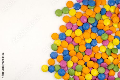 Colorful candies or colored dragees isolated on a white background with copy space for text. photo