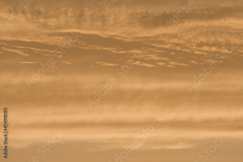 Abstract sky background of deep golden sunset clouds. Full frame © Rhys