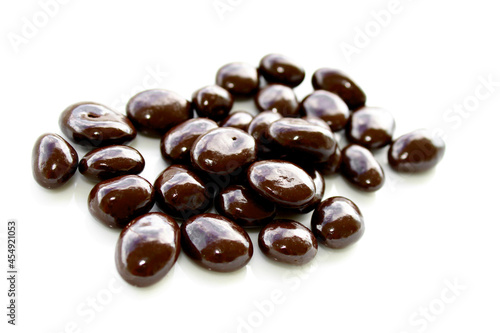 Chocolate covered nuts on white background, sweets with chocolate 